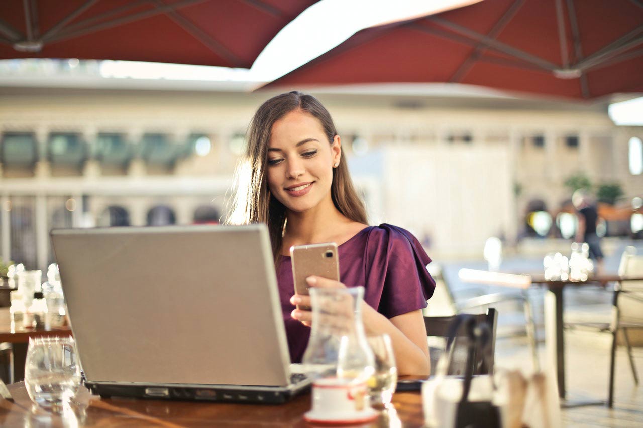 Old Laptop and Phone Woman with old laptop and phone