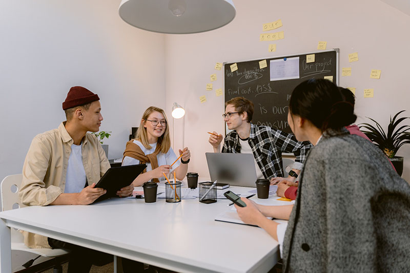 Startup company discussing project around a desk